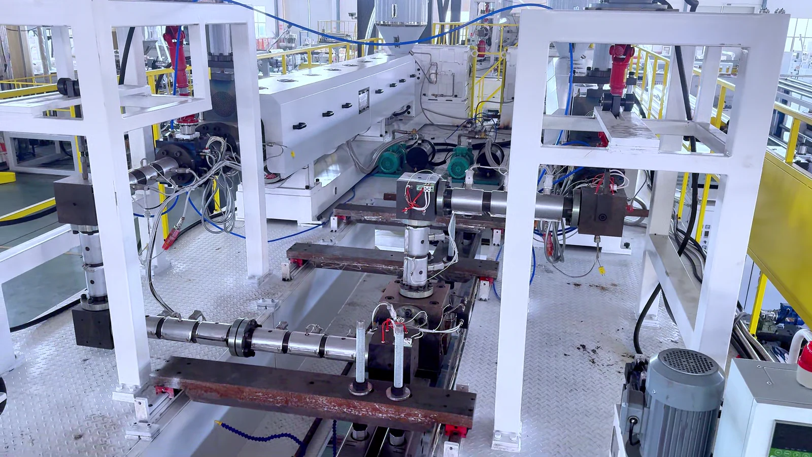Detailed wide view of a geomembrane production-line die and downstream structure